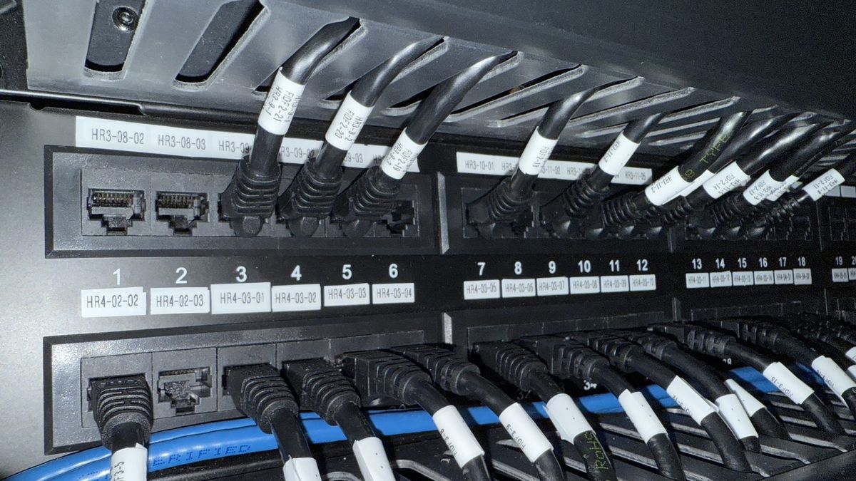 Neatly labeled network patch panel and cabling, showing Enlightened Audiovisual installation standards